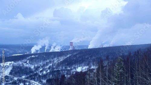 Chemical plant in Gubakha. Puffs of smoke from the factory's chimneys. View of the factory from Krestovaya Mountain in winter. View of the smoking pipes from the ski slope. Environmental problems. 4K photo