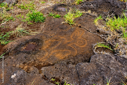 Petroglyph of birdman carved on the lava rock at the restored ceremonial site of Ahu Tongariki on Easter Island (Rapa Nui), Chile. photo