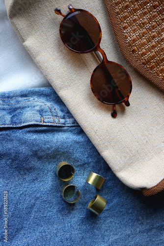 White blouse, denim skirt, vintage bag, sunglasses, pearl barrettes and gold jewelry. Top view.