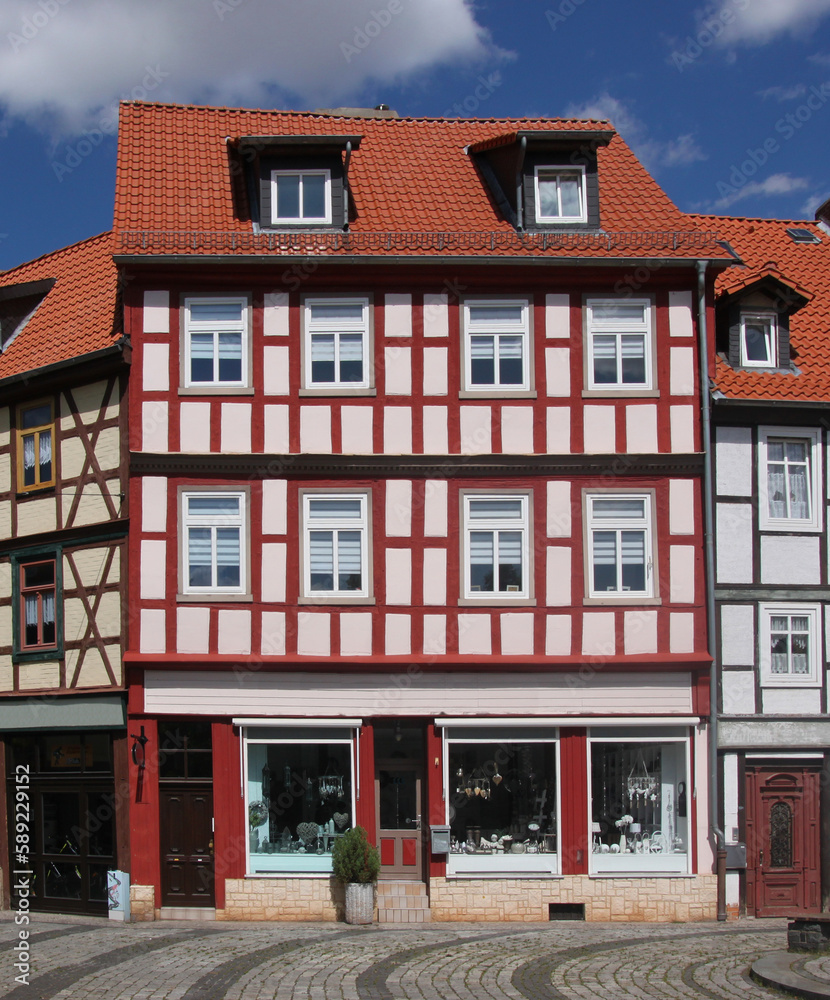 Half-timbered side-gabled house with shop windows in the old medieval town of Halberstadt, Germany