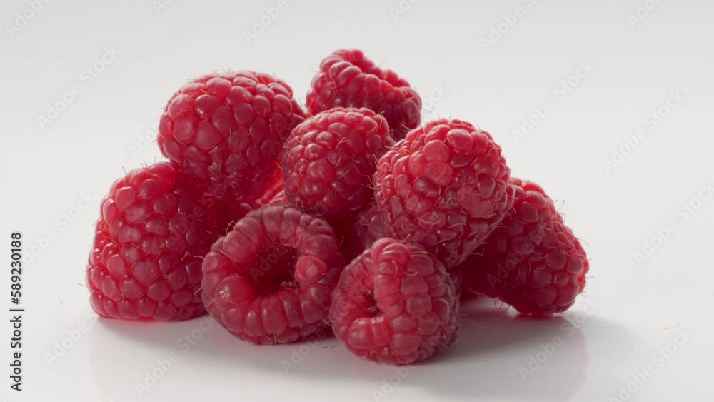 A Close-Up Of Fresh And Tasty Raspberry Rotating. On White Background. A Close-Up Of Fresh And Tasty Raspberry Rotating. On White Background.