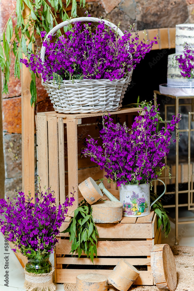 Birthday decoration with lavender flowers on wooden boxes and sweet cake behind
