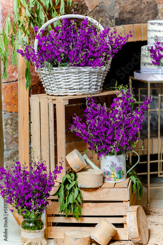Obraz na płótnie Birthday decoration with lavender flowers on wooden boxes and sweet cake behind w salonie
