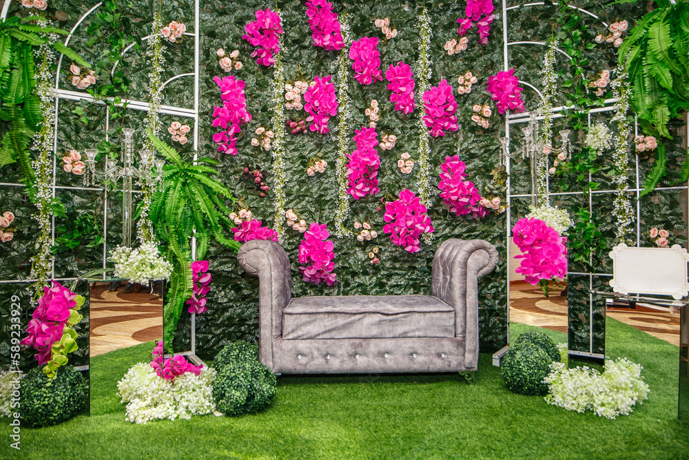 Luxurious wedding decoration with textured greens, artificial flowers and mirrors