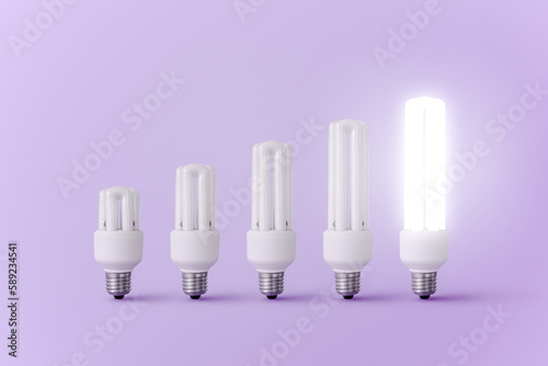 Set of light bulbs and one burning bulb of different sizes photo