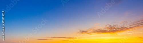 clouds and orange sky,Real majestic sunrise sunset sky background with gentle colorful clouds without birds.Panorama, large © banjongseal324