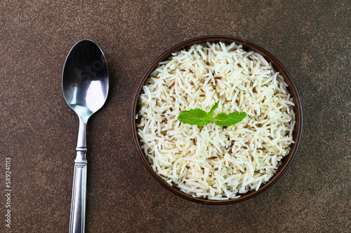 Serving jeera rice also known as cumin rice in a bowl. photo