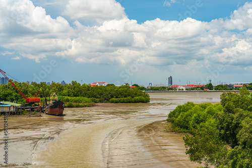 Rivers of ferry terminals and fisherman's piers at estuary during low tide in Thailand.