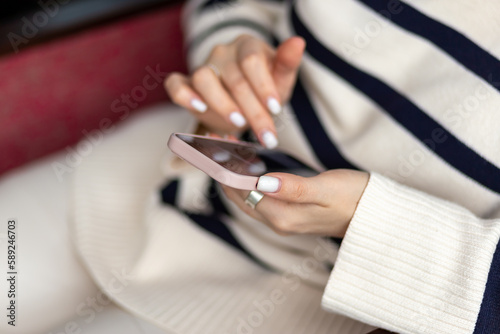 female hands are holding a mobile phone