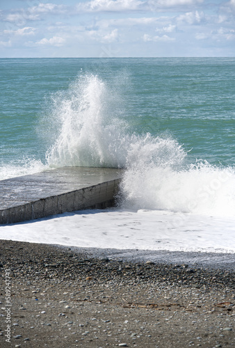 The wave crashes on the sea pier