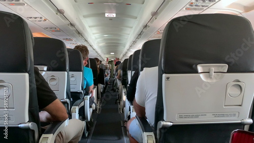 Back of airplane interior. passenger perspective in plane corridor
