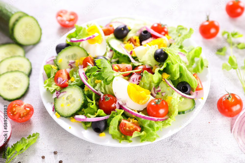 healthy vegetable salad with fresh lettuce,  tomato, cucumber and egg- diet food, healthy eating concept