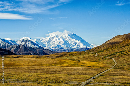 Tour Bus Driving Past Denali in Denali National Park, Alaska
