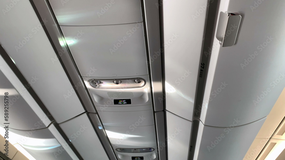 Airplane ceiling, close-up of plane detail overhead luggage Airplane ceiling, close-up of plane detail overhead luggage