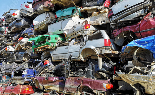 Stacked crushed cars in scrap yard
