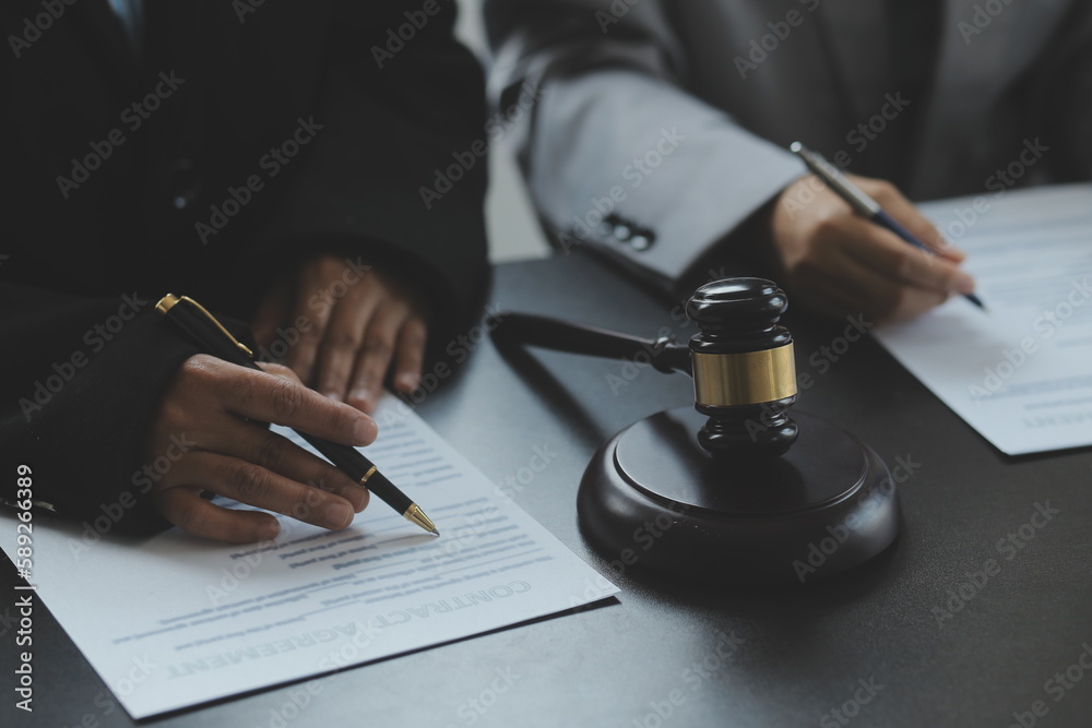 Judge gavel with Justice lawyers having team meeting at law firm in background. Concepts of law. Judge gavel with Justice lawyers having team meeting at law firm in background. Concepts of law.