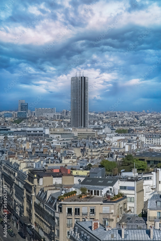 Paris, beautiful Haussmann facades and roofs in a luxury area of the capital, view from the triumph arch, with the Montparnasse tower
