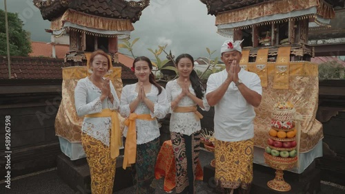 Portrait of Beautiful Balinese Family Using Traditional Clothes Dress Clothing at Home Temple in Bali Indonesia Culture Religion photo