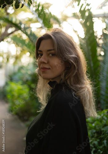 Young woman in botanical garden. She explore different types of trees. Botany, 	arboretum, hortus botanicus in amsterdam, netherlands. photo