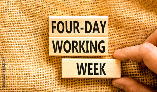 Four-day working week symbol. Concept words Four-day working week on wooden block on a beautiful canvas table canvas background. Businessman hand. Business four-day working week concept. Copy space. photo