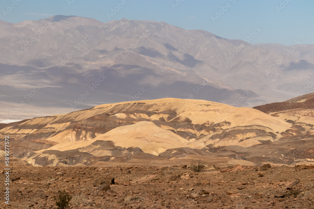 Scenic view of colorful geology of multi hued Artist Palette rock formations in Death Valley National Park, Furnace Creek, California, USA. Black mountains and Amargosa Chaos seen from Artist Drive