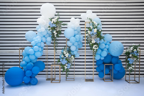 decor with balloons of white, blue and flower arrangemets. Party decorations. Blue and white.