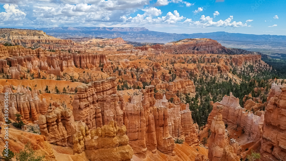 Scenic aerial view of massive hoodoo sandstone rock formation towers on Navajo trail in Bryce Canyon National Park, Utah, USA. Natural unique amphitheatre in summer. Dark clouds emerging to storm