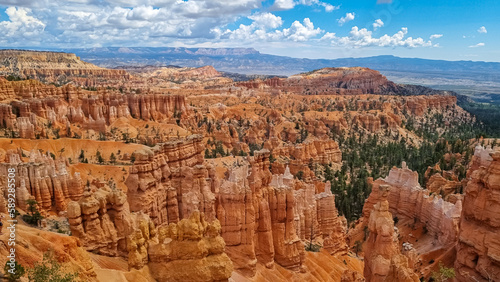 Scenic aerial view of massive hoodoo sandstone rock formation towers on Navajo trail in Bryce Canyon National Park, Utah, USA. Natural unique amphitheatre in summer. Dark clouds emerging to storm