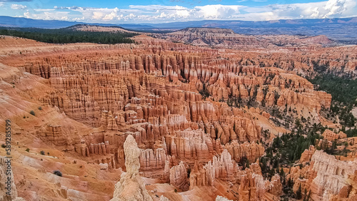 Panoramic aerial view of massive hoodoo sandstone rock formations in Bryce Canyon National Park, Utah, USA. Natural unique amphitheatre sculpted from the reddest rock of the Claron Formation. Awe