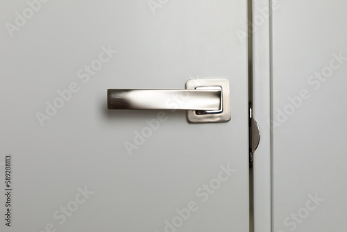 Close-up door locks for reliable protection of the apartment door. Door handle with white door panel. Close-up. Entrance door. place for text. copy space.