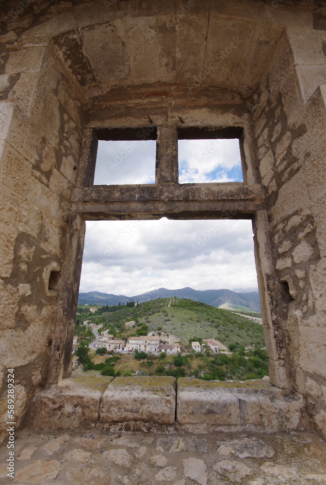The Tirino valley seen through an opening in a window of the Piccolomini Castle in Capestrano (AQ)