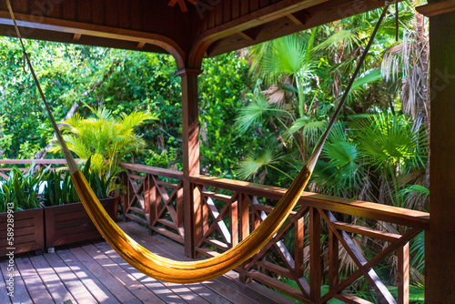 yelllow hammock on a patio at a resort in the tropics photo