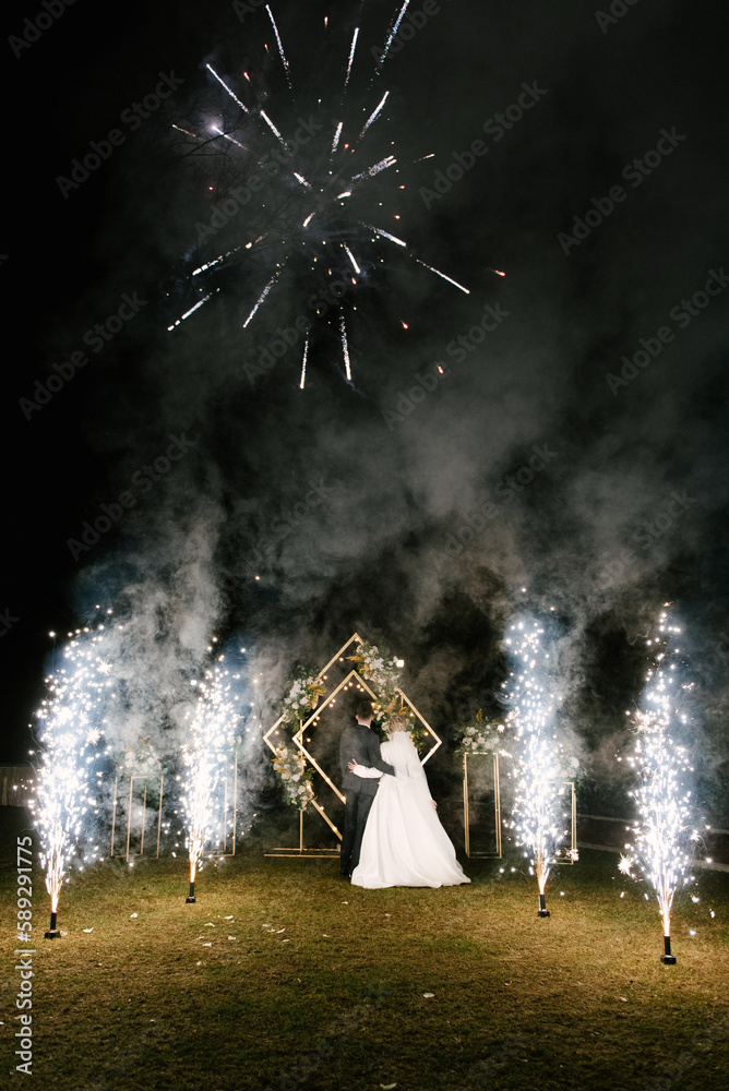 The bride and groom. The night by the light of fireworks.
