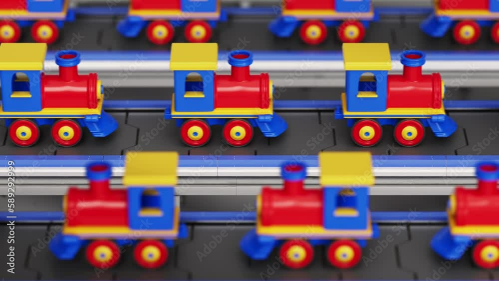 Multiple train toys in various colours moving on the mass production conveyor system. Automated mass production system at the industrial facility. Conveyor belt system deals with mass toy production