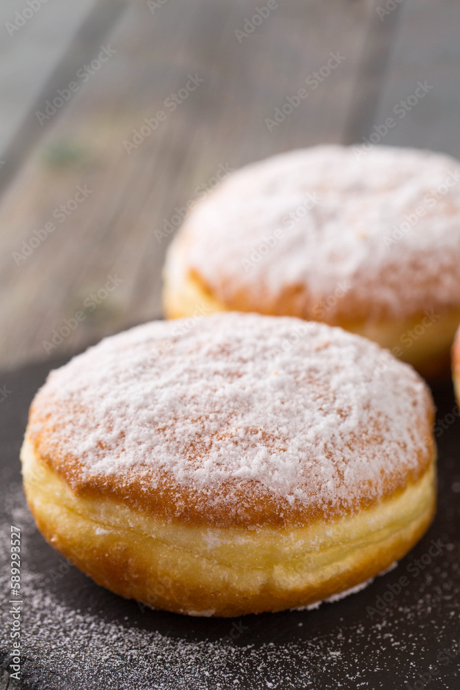 Ruddy donuts berliners on a stone board Ruddy donuts berliners on a stone board