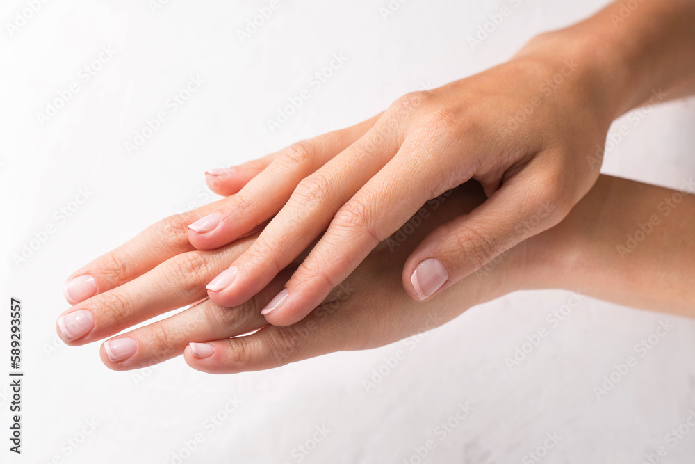 Female hands with french manicure on white background