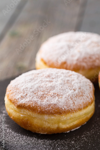 Ruddy donuts berliners on a stone board