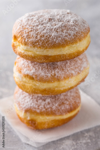 Three donuts stand on top of each other