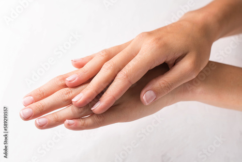Female hands with french manicure on white background