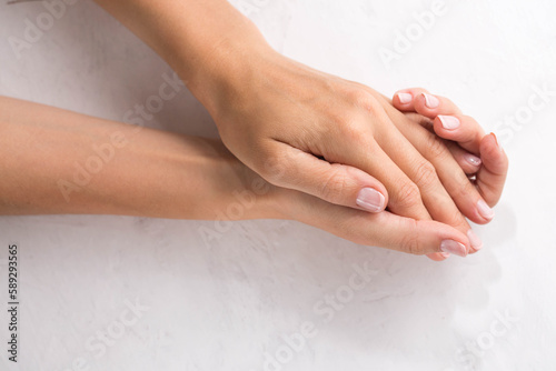 Female hands with minimalist french manicure