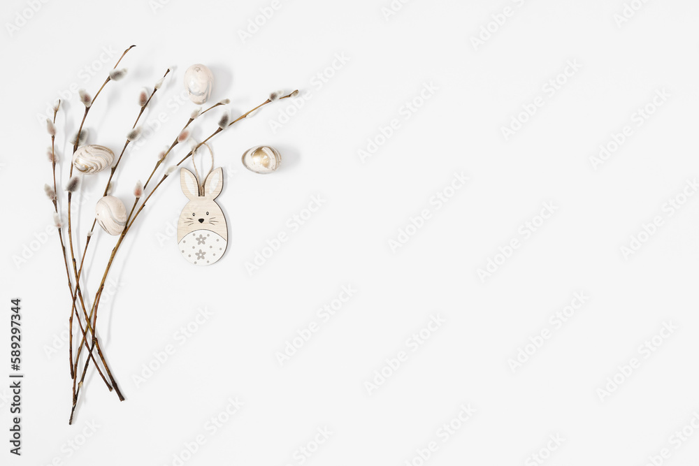 Easter trendy composition. willow plant branches, easter eggs and bunny on white background. Minimal concept Easter. Flat lay, top view, copy space