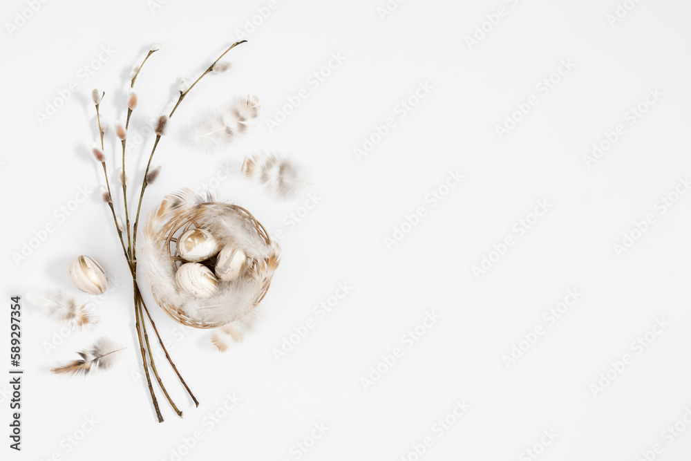 Easter holiday composition.Top view of Easter eggs in nest, feathers, rabbit, willow plant branches on light beige and white background. Minimal concept Easter. Flat lay, copy space Easter holiday composition.Top view of Easter eggs in nest, feathers, rabbit, willow plant branches on light beige and white background. Minimal concept Easter. Flat lay, copy space