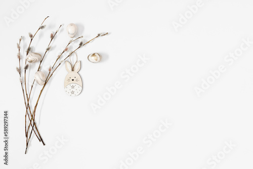 Easter trendy composition. willow plant branches  easter eggs and bunny on white background. Minimal concept Easter. Flat lay  top view  copy space