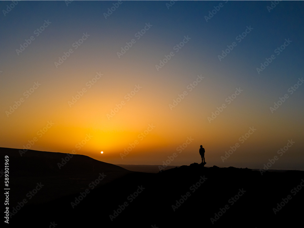 Watching a beautiful sunset from a high vantage point from a volcano near Corralejo in Fuerteventura Spain