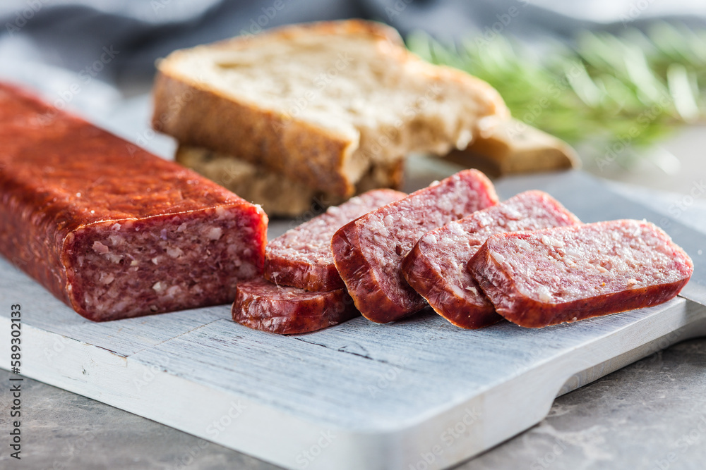 Smoked .sausage. Sliced salami on cutting board. Smoked .sausage. Sliced salami on cutting board.