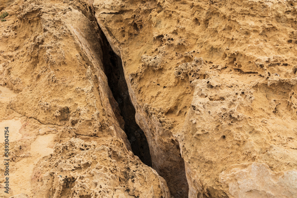 A large deep crack in the ground. Detached earth plates after an earthquake, large crack