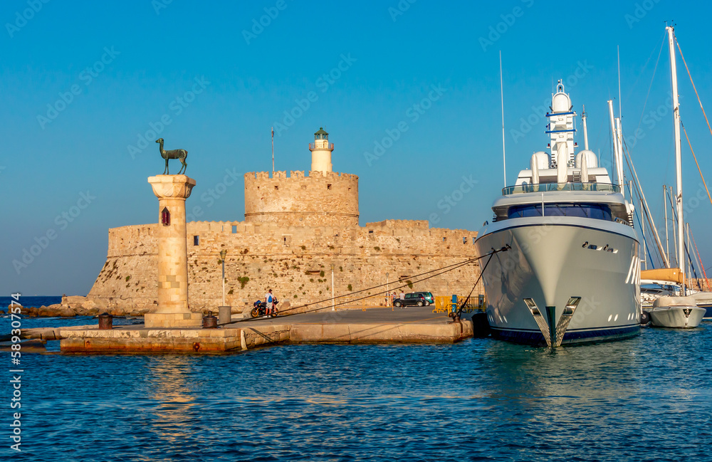 Fort of St. Nicholas and column with deer statue in Mandraki harbor of Rhodes, Greece Fort of St. Nicholas and column with deer statue in Mandraki harbor of Rhodes, Greece