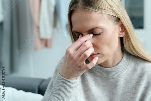 tired woman feel pain and touching dry eyes photo