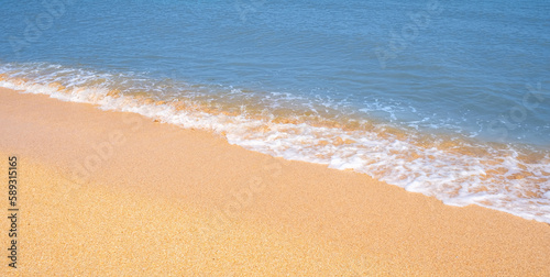 The coast of the Sea of Azov. Sea waves roll on the sandy shore. Seashell sandy beach.