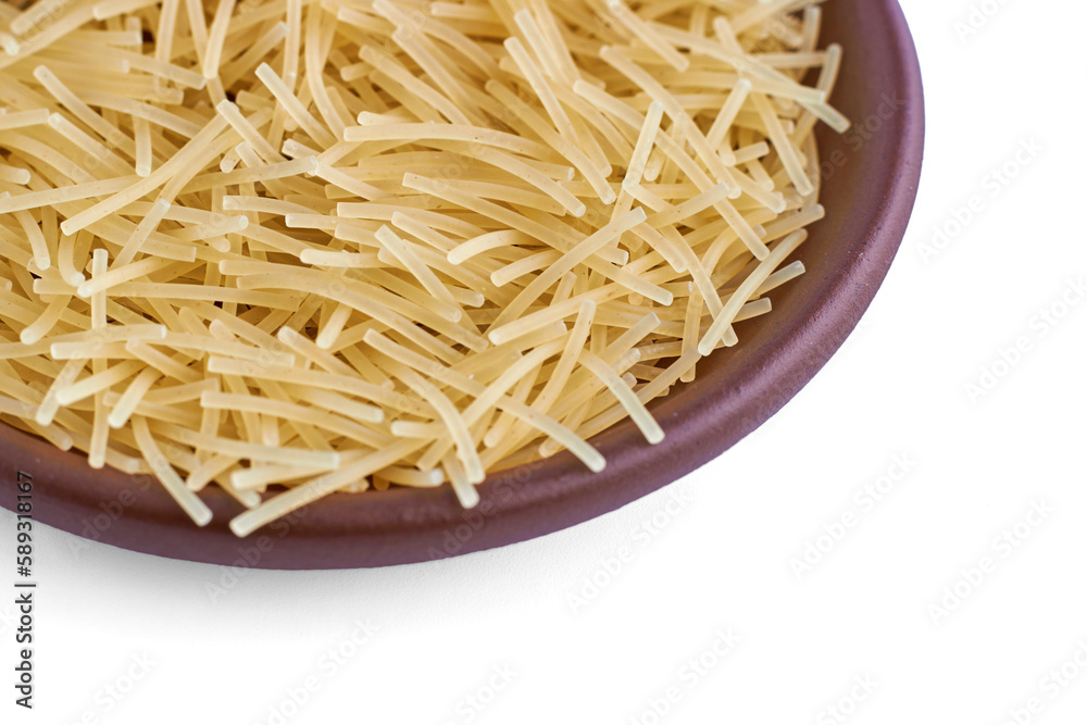 Pasta noodles in a clay ceramic bowl close-up isolated on a white background Pasta noodles in a clay ceramic bowl close-up isolated on a white background